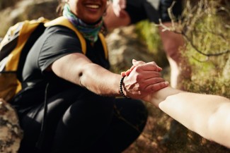 Two people reaching to each other